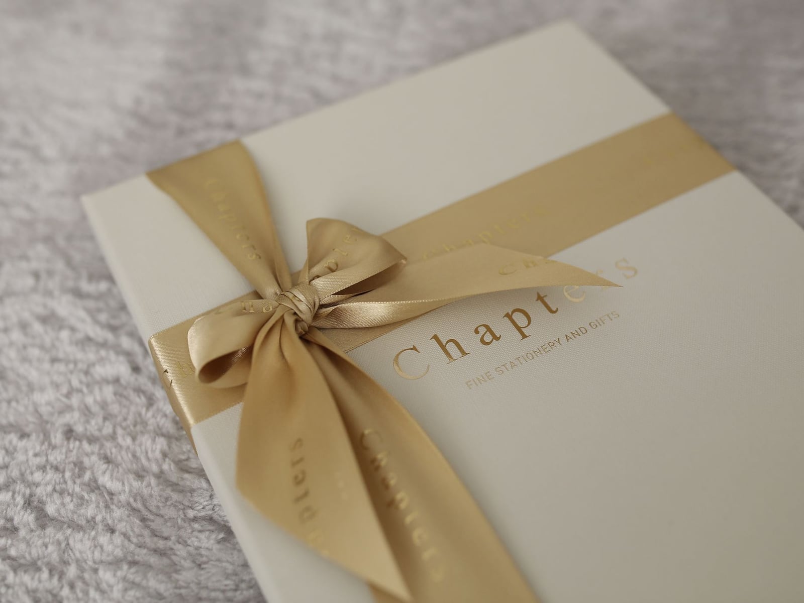 An open luxury leather clamshellhell box protecting a rare book edition.
